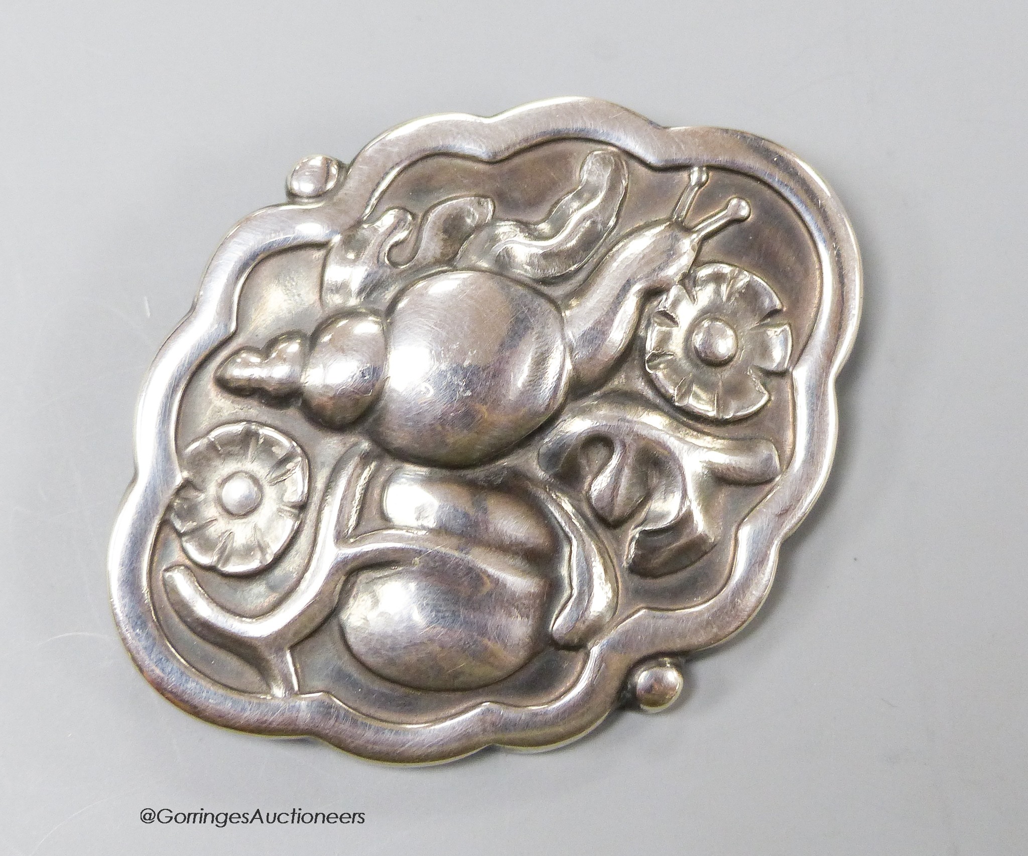 A Georg Jensen cartouche shaped sterling brooch depicting a snail amid foliage, design no. 279, 55mm.